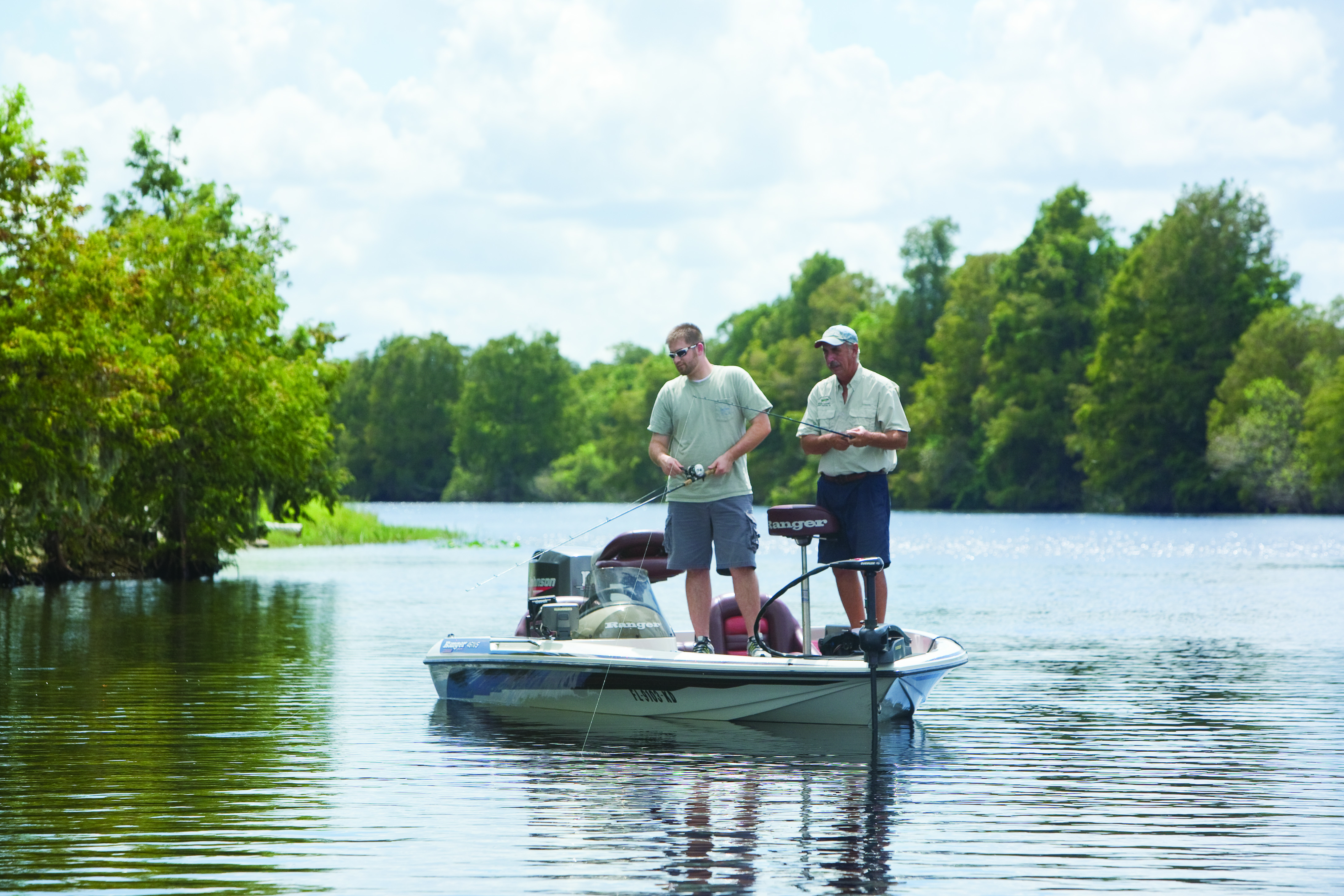 Two men fish from a small boat at Camp Mack's River Resort