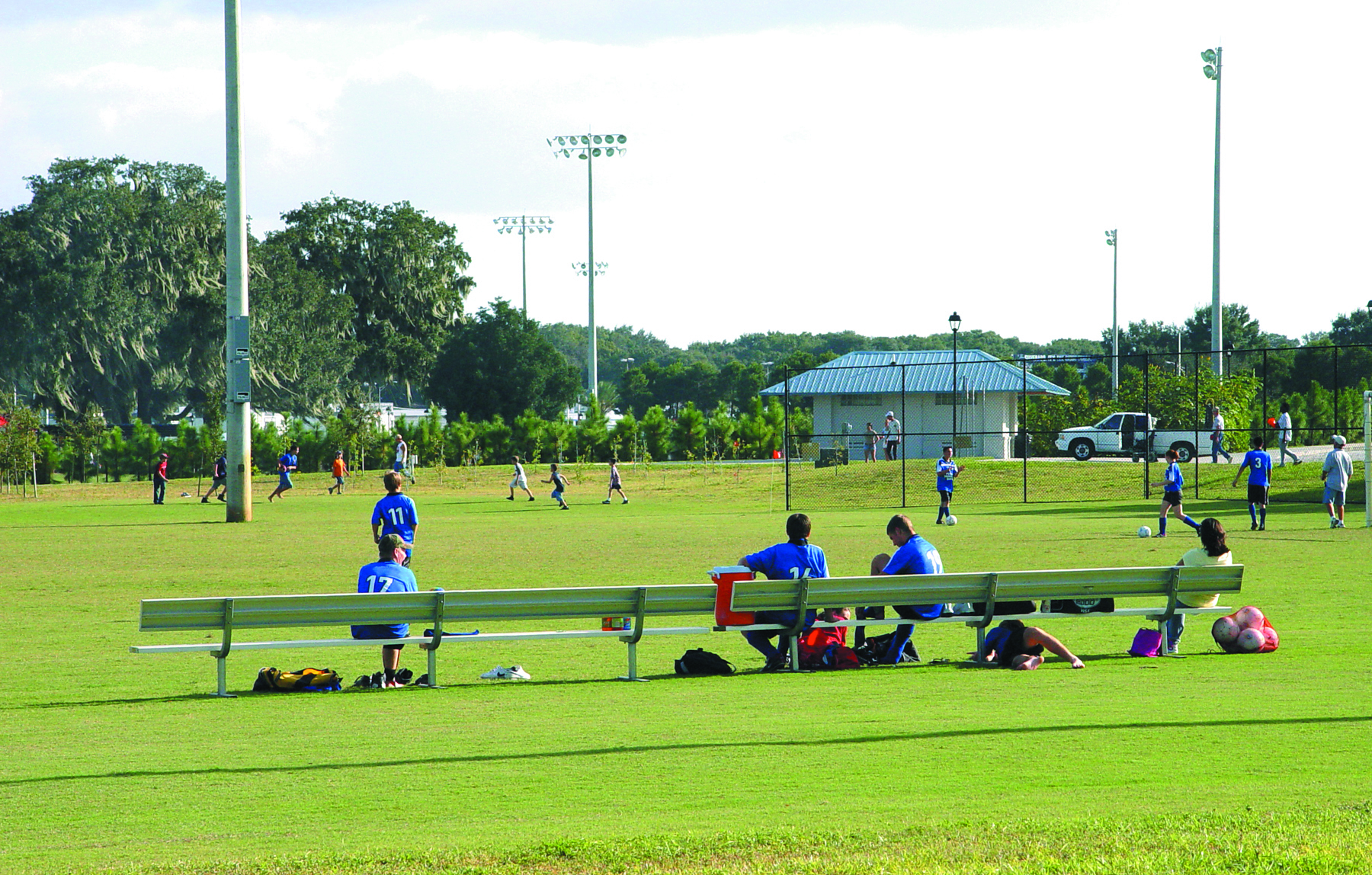 Soccer players watch the game at Lake Bonny Park