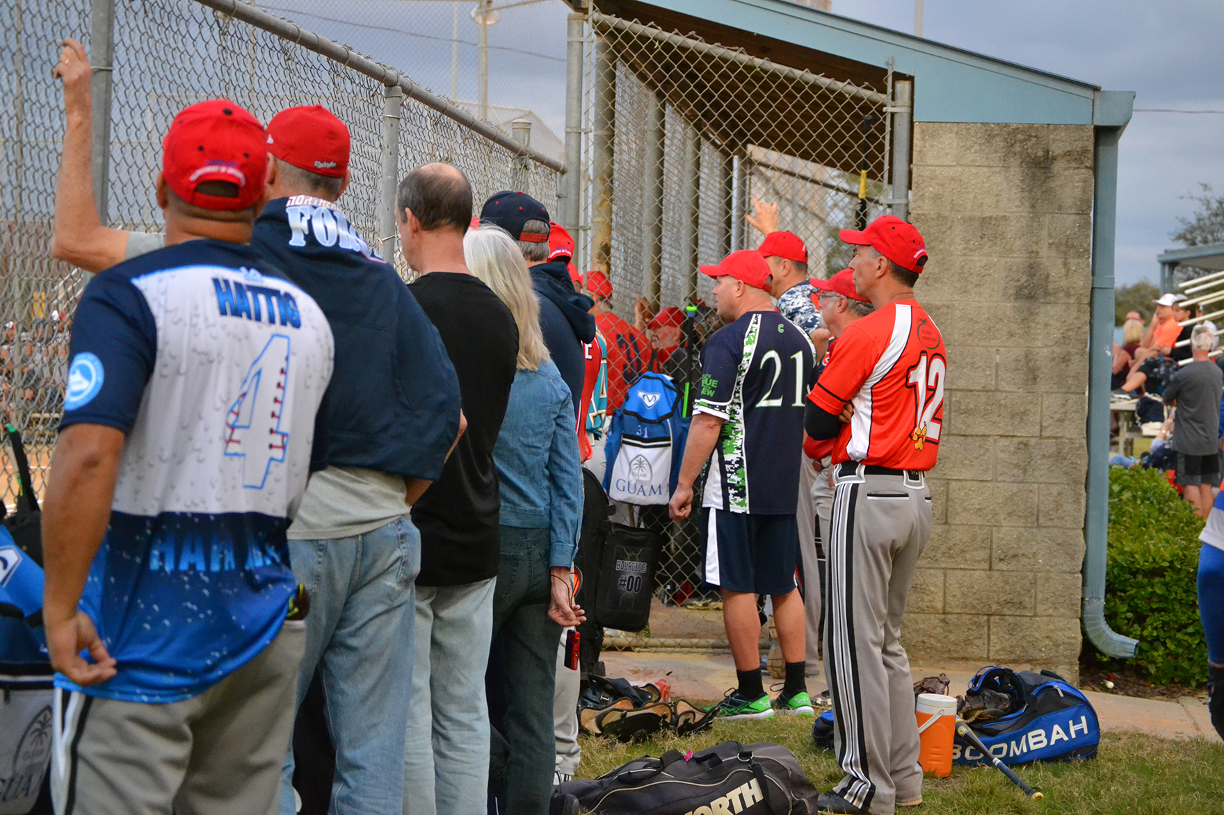 Players watch the action during a senior softball event