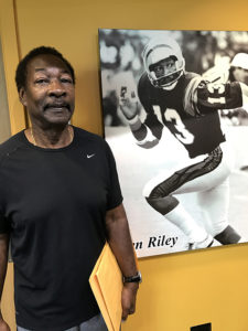 Former NFL superstar Ken Riley stands next to his display in the Polk County Sports Hall of Fame