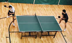 Two players volley during a table tennis match