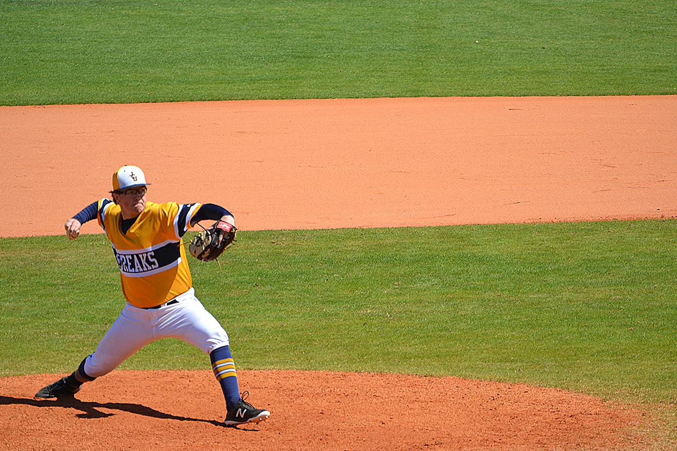A pitcher throws the ball from the mound during a baseball game at Chain Of Lakes Park in Winter Haven.